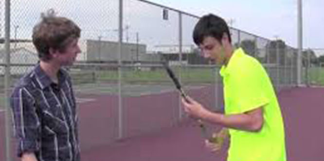 Aaron Dills, 12, shows Jonathan Kane, 12, a thing or two about tennis.