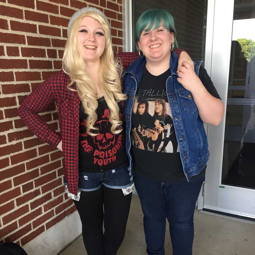 Senior Rebecca Slone and junior Maya Gay pose for a picture in their Decade Day outfits. 