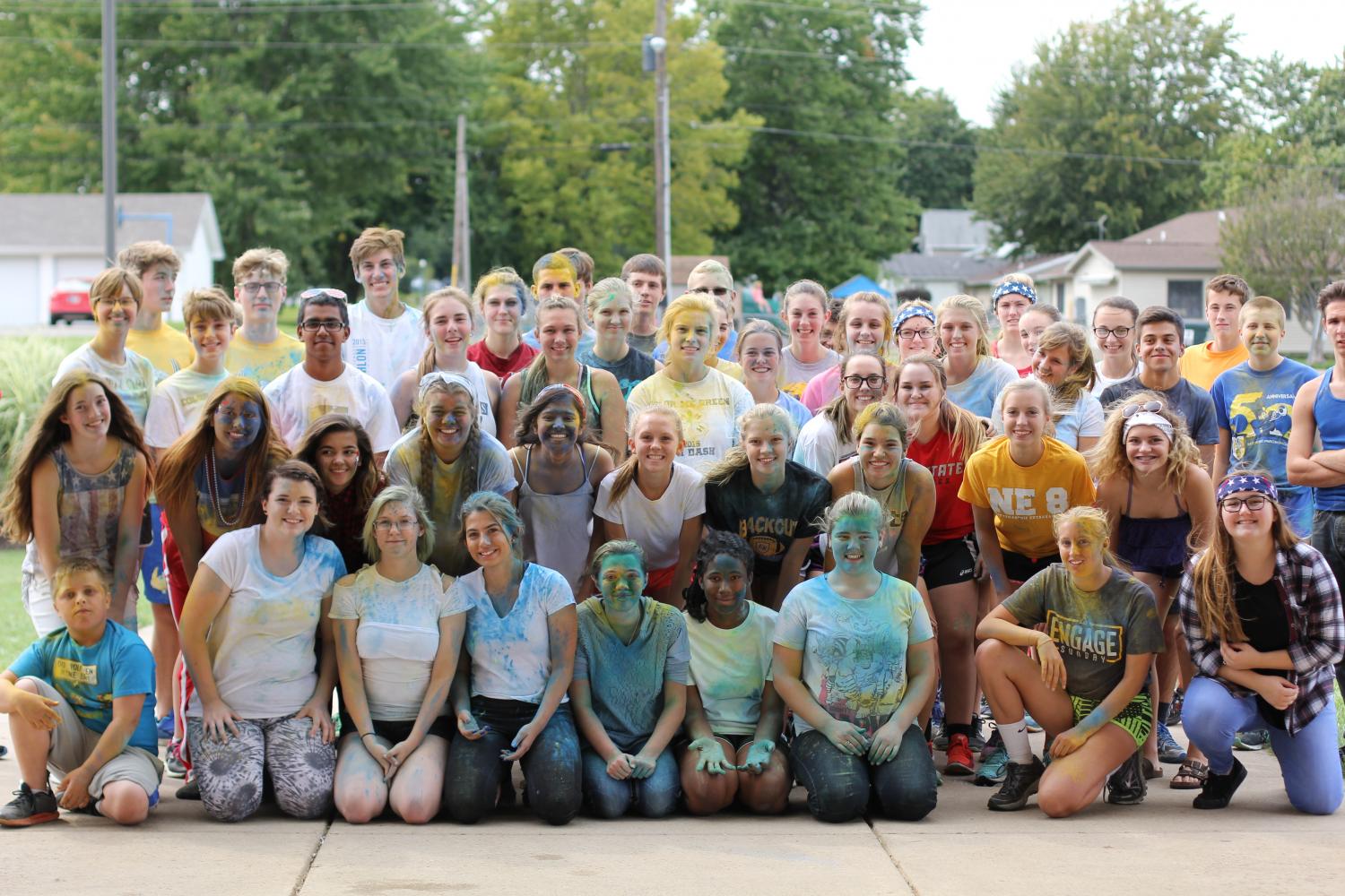 A group photo of students doused in color after participating in the race.